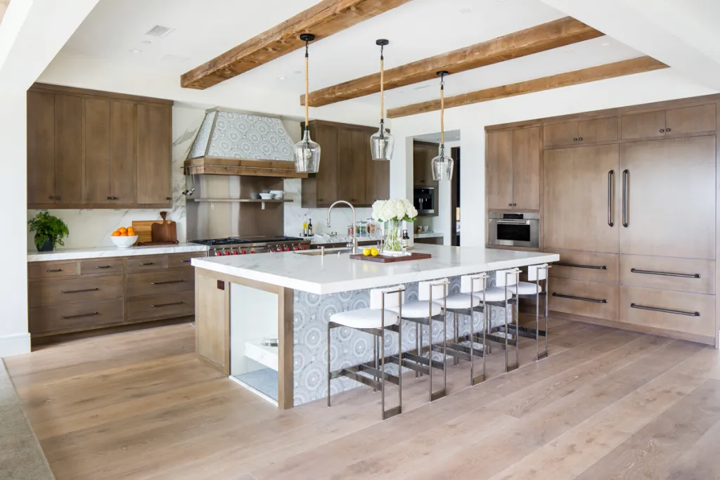 grey and white patterned tile on kitchen island and hood with natural wood kitchen cabinets