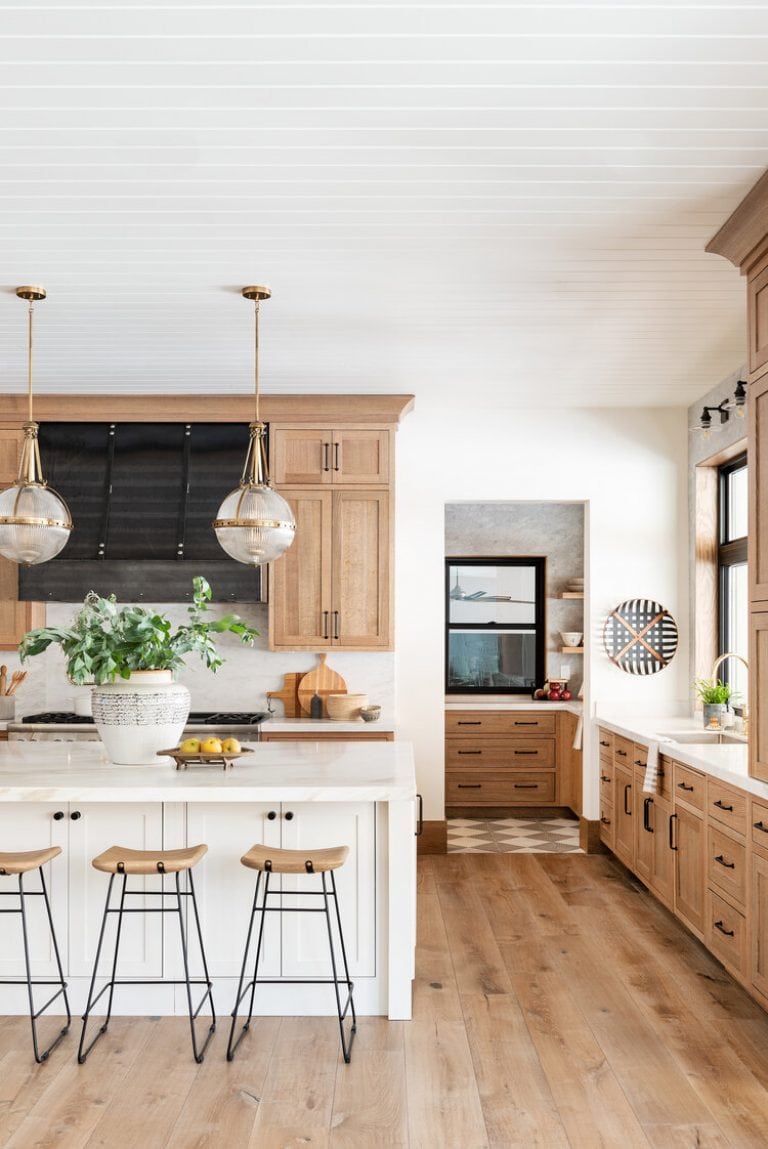 natural wood kitchen cabinets mixed with white kitchen island. Opens to a coordinating butlers pantry