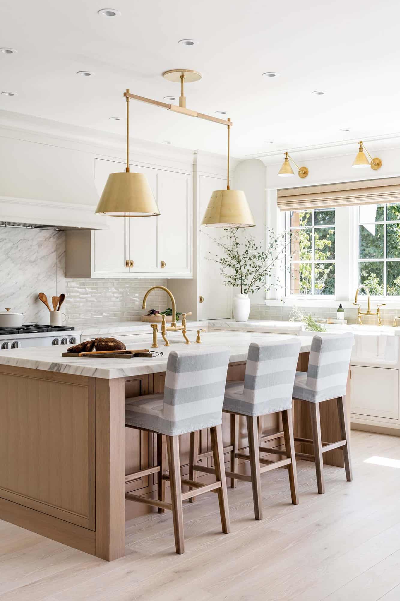 A neutral kitchen design with pops of grey and gold.