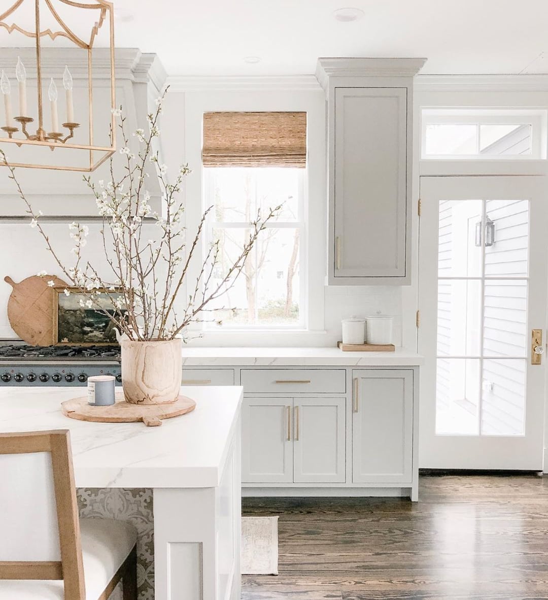 light grey kitchen cabinets with wood accents. 