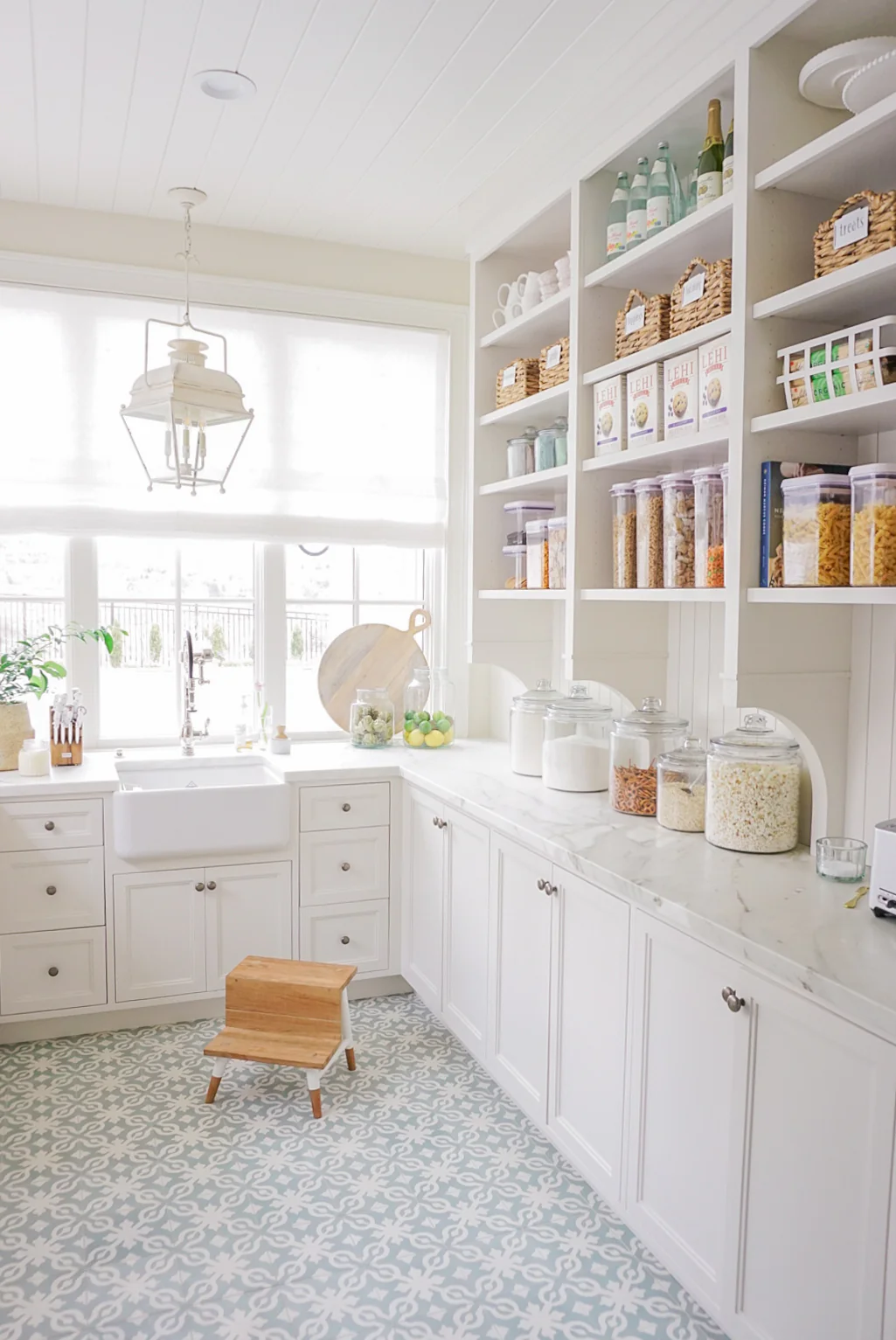 walk in pantry with blue gray tile flooring. Canisters used to organize ingredients