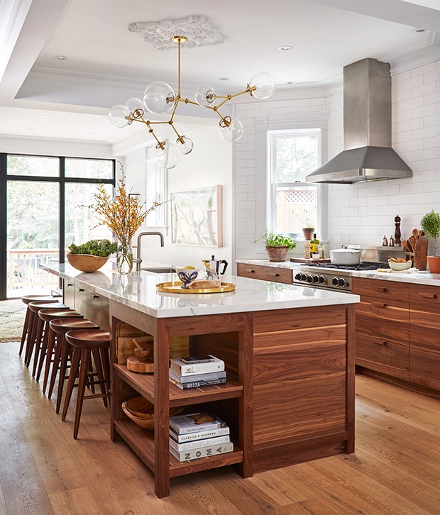 walnut wood kitchen with stainless steel hood. 