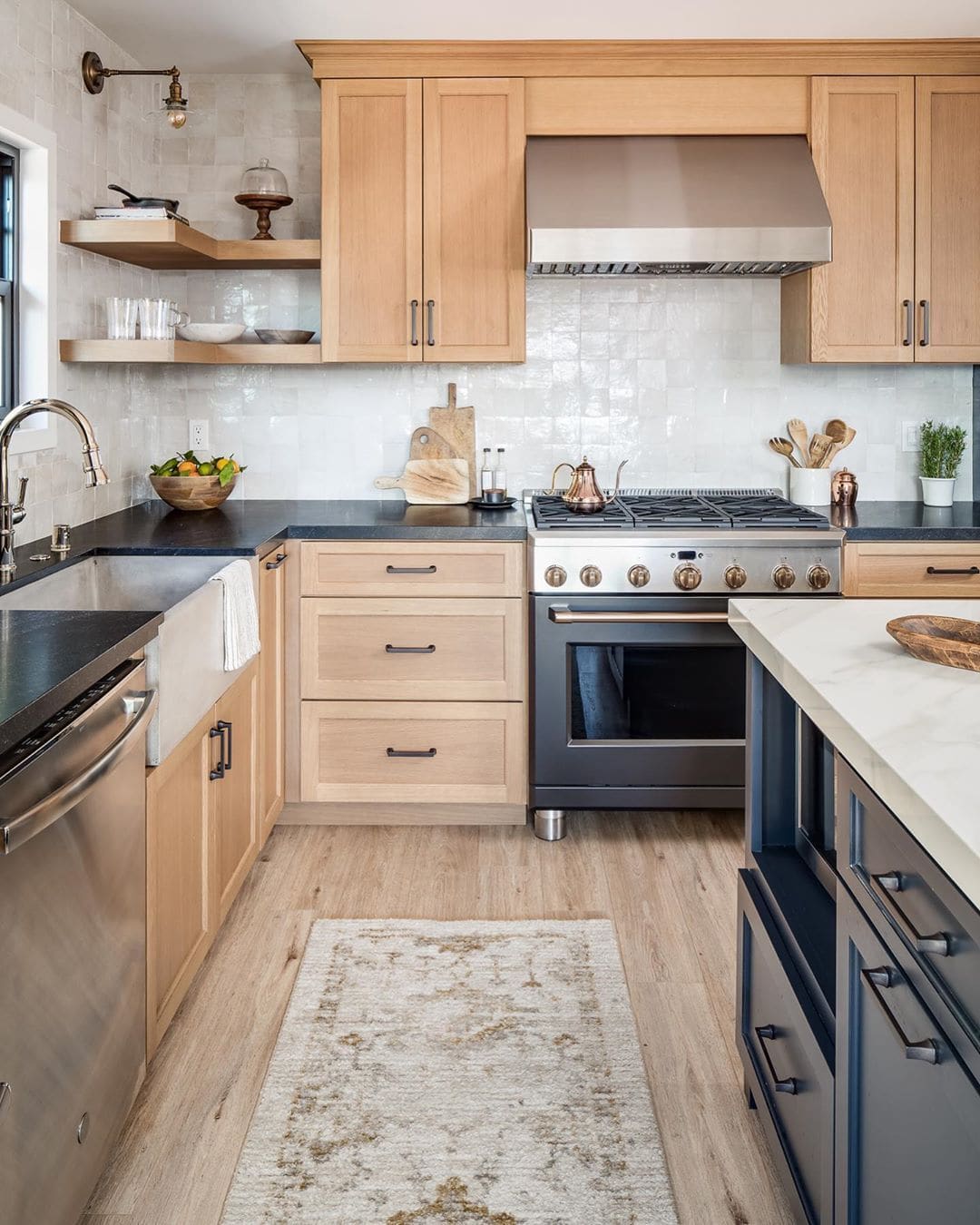 light wood kitchen cabinets with navy island.