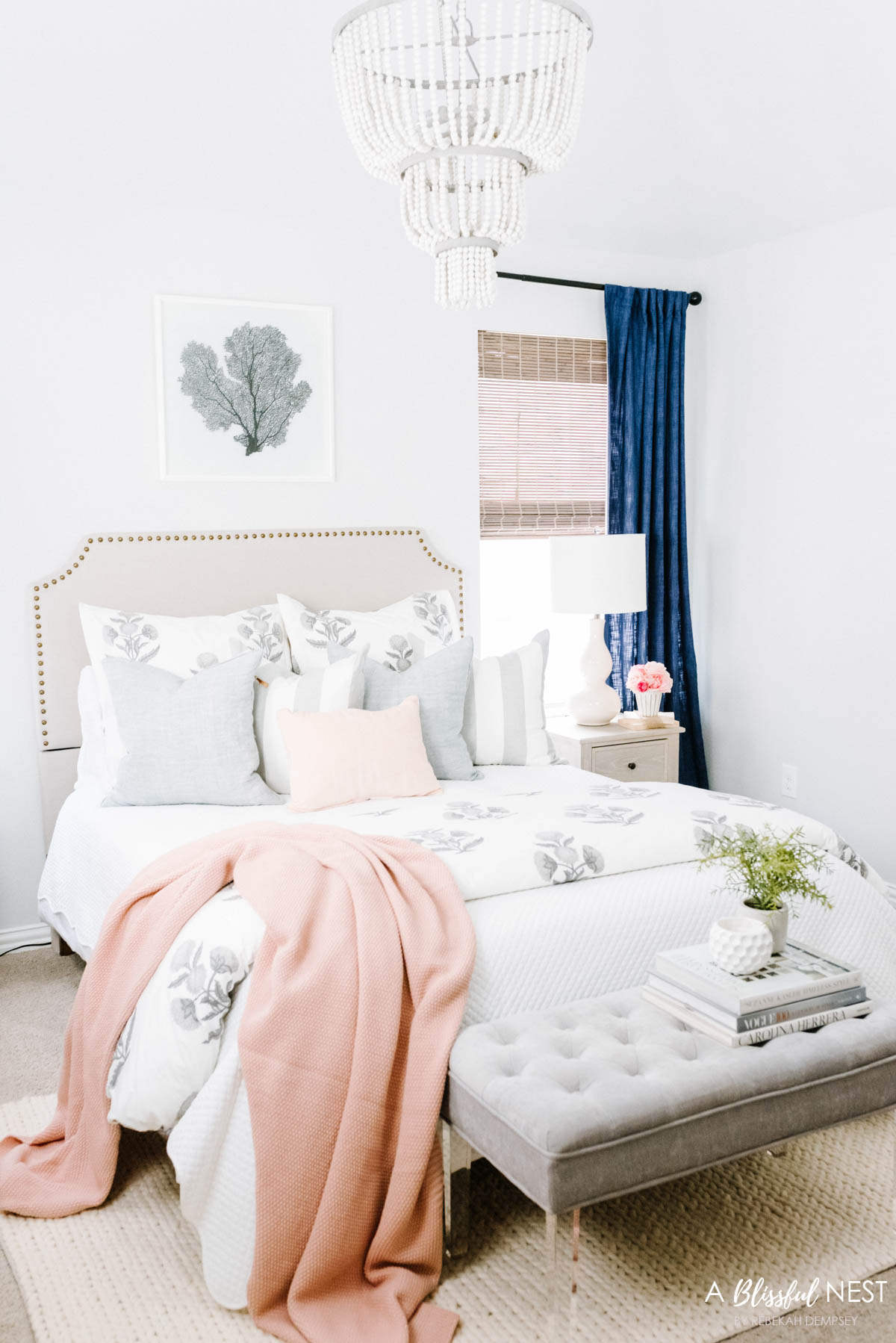 navy drapes, grey and white bedding with light pink accents