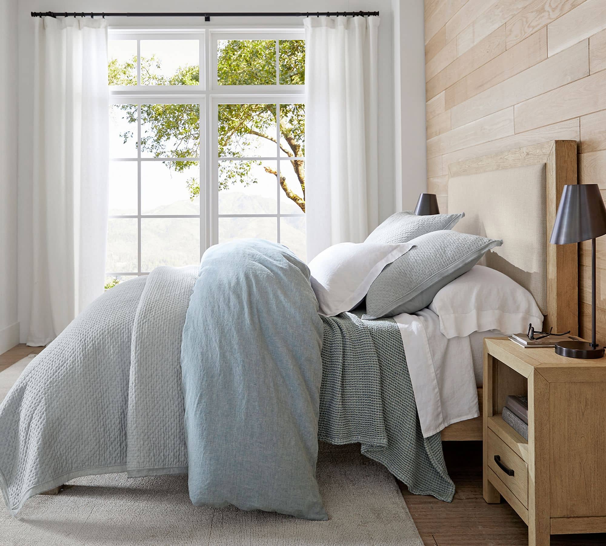 bedding in soft blue green color mixed with white sheets
