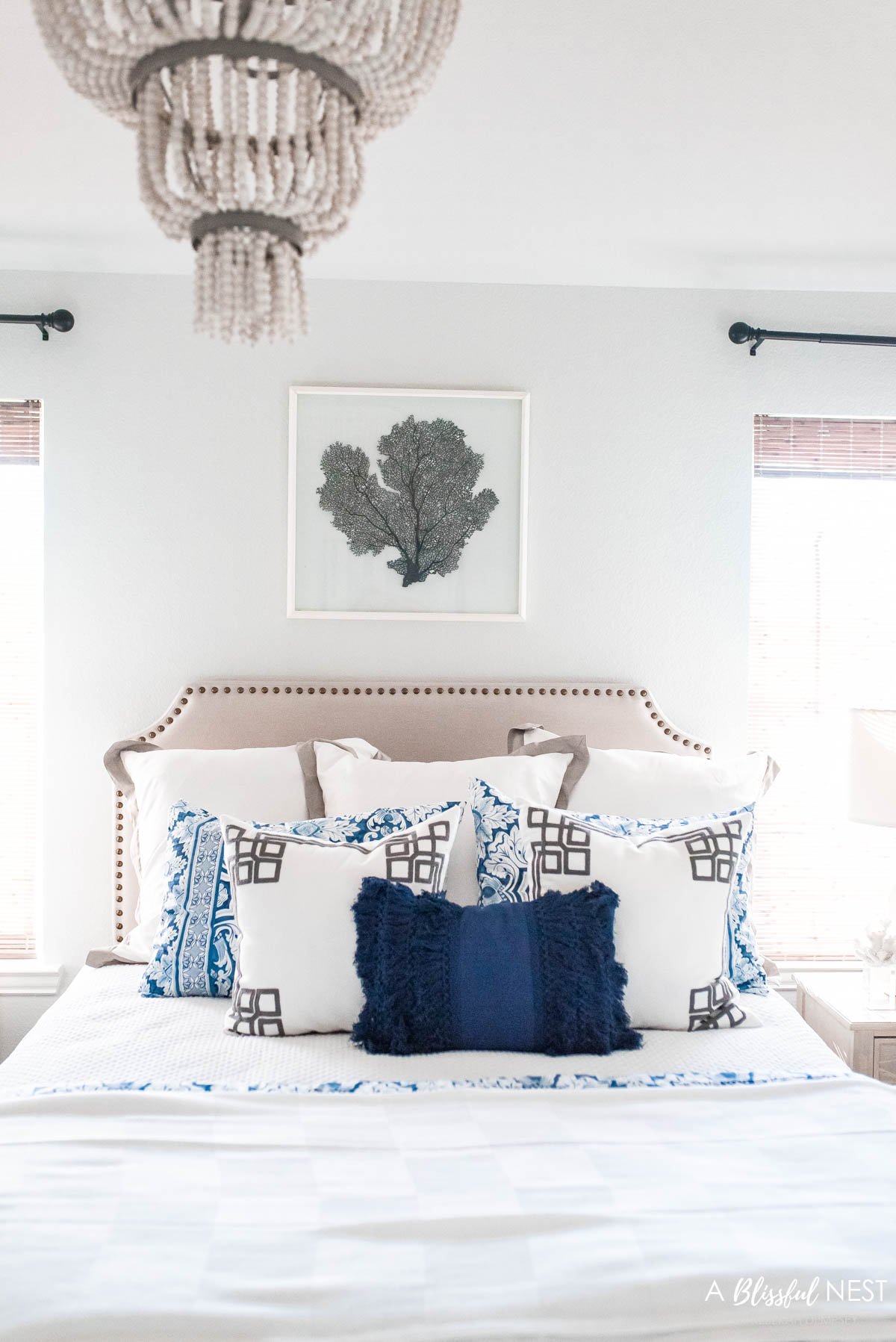 blue and white bedding with navy blue accent pillow in front