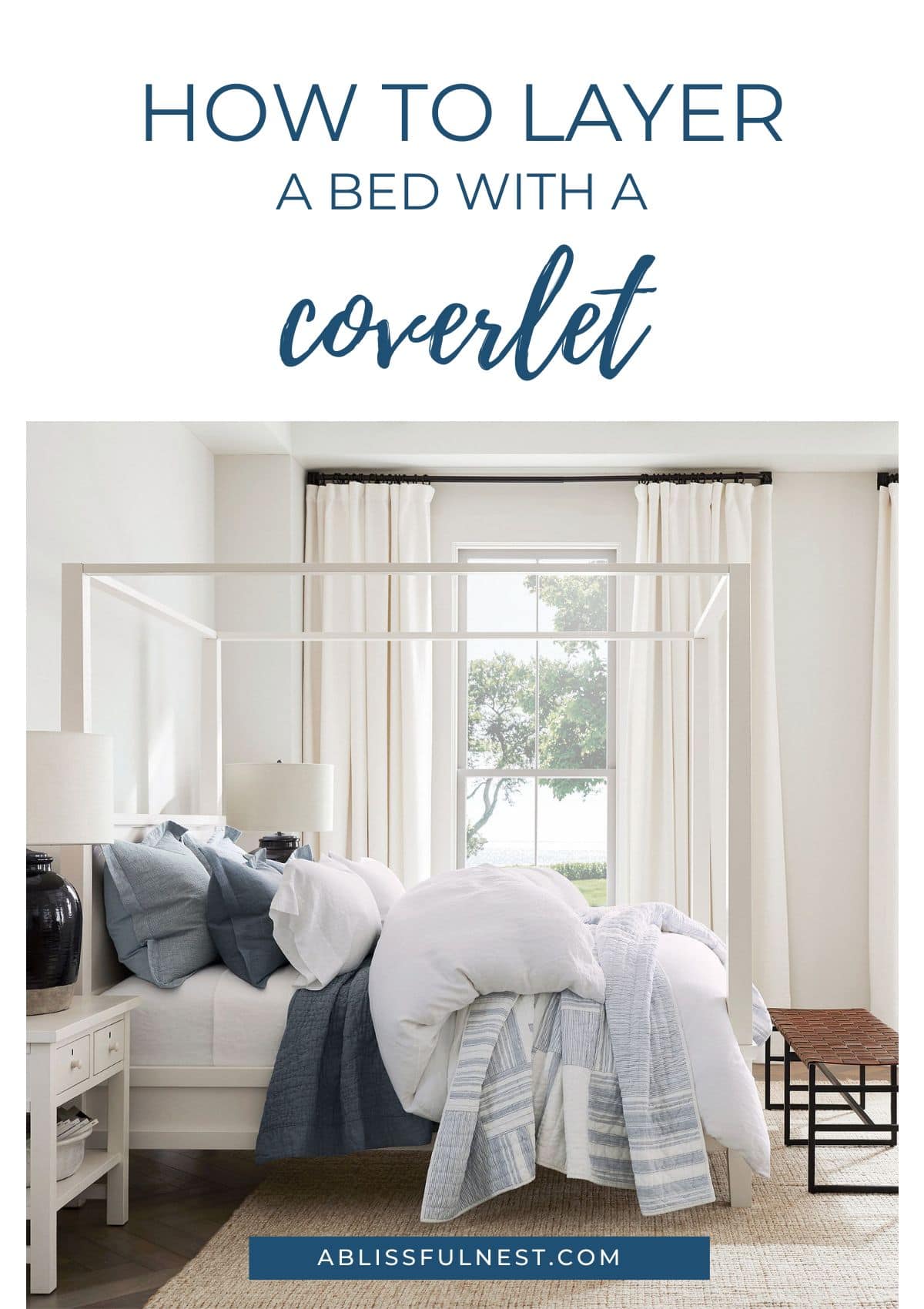 white bed, navy and light blue bedding, leather bench at end of bed