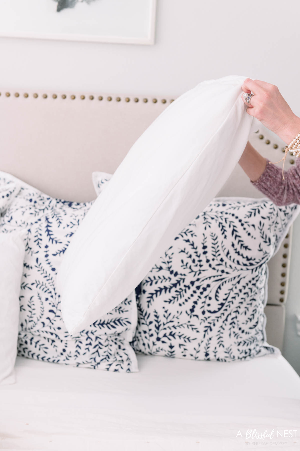 white bed pillow cover being put on a pillow