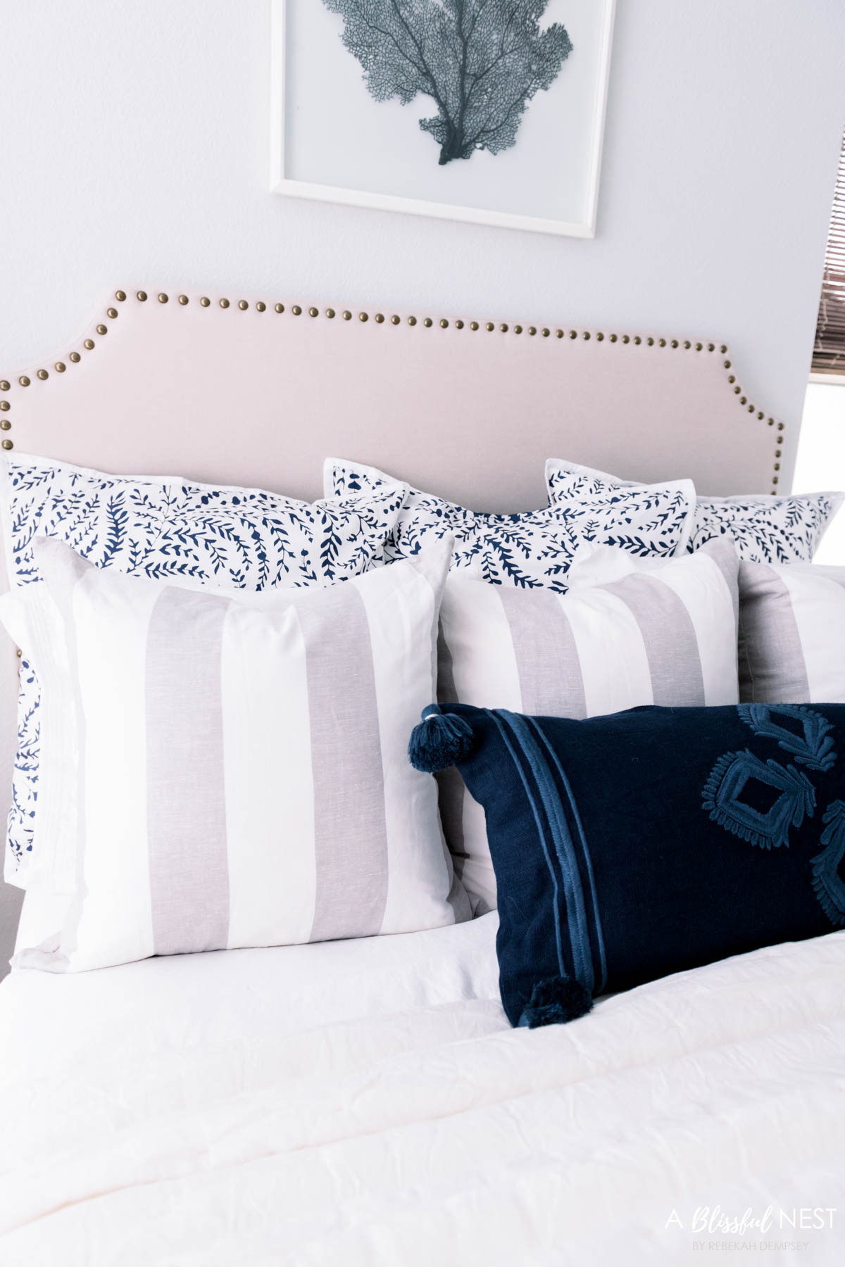 3 layers of pillows on a bed create a cozy look