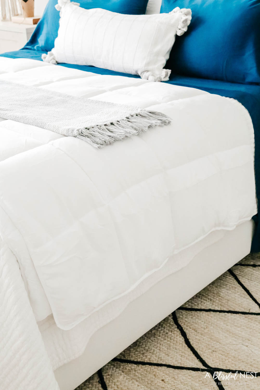 a lightweight blanket is drapped across the end of the bed for extra warmth