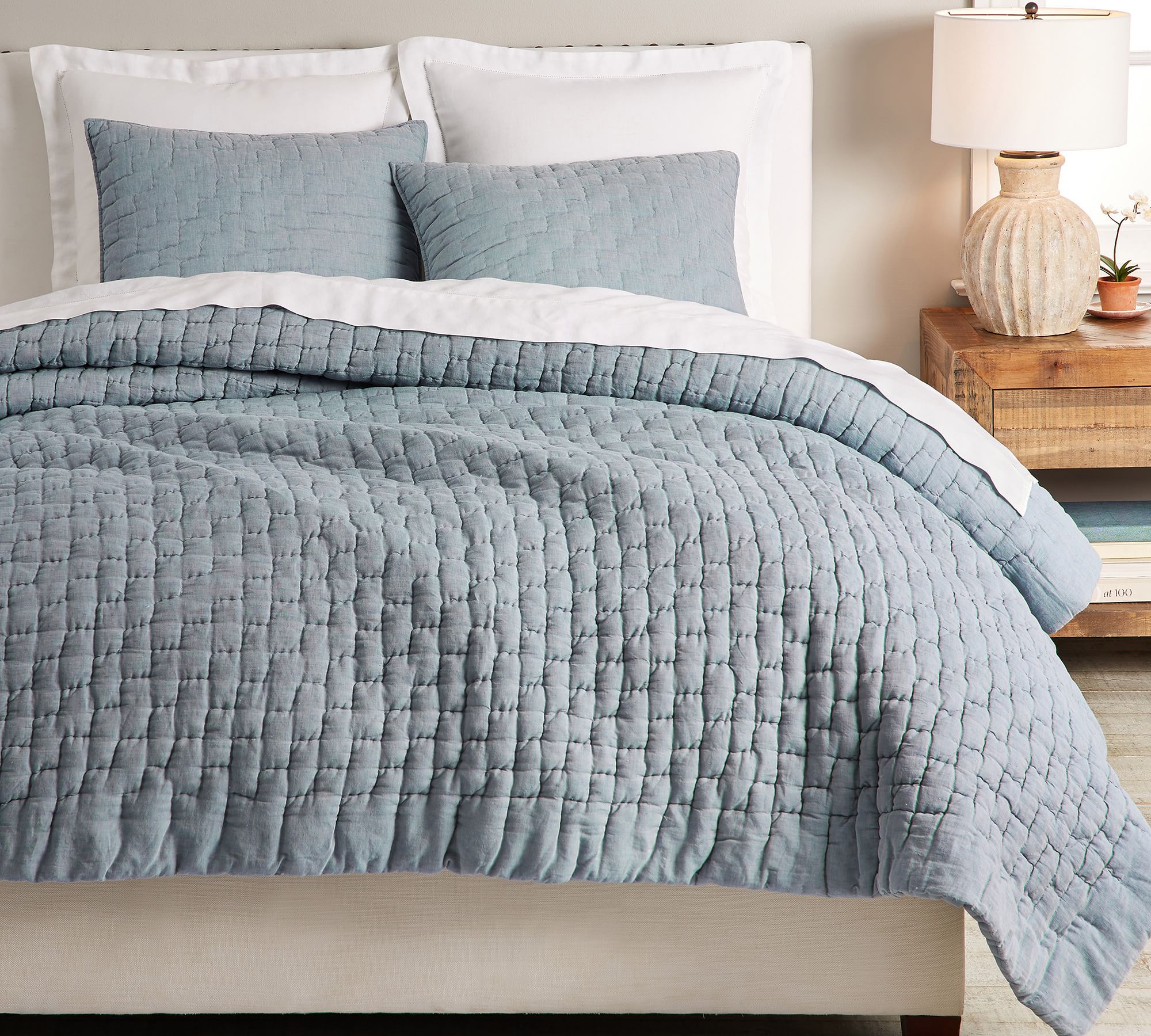 soft blue gray quilt mixed with white bedding