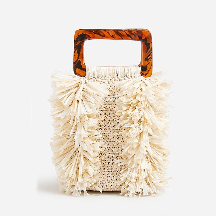 This raffia woven tote has the prettiest acrylic handle - it's the perfect summer statement handbag! #ABlissfulNest