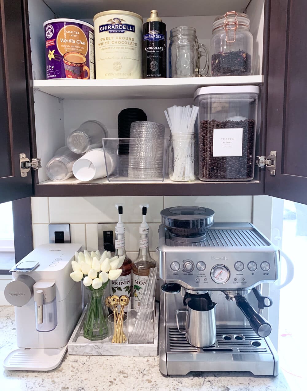 espresso machine with a upper cabinet filled with coffee ingredients.