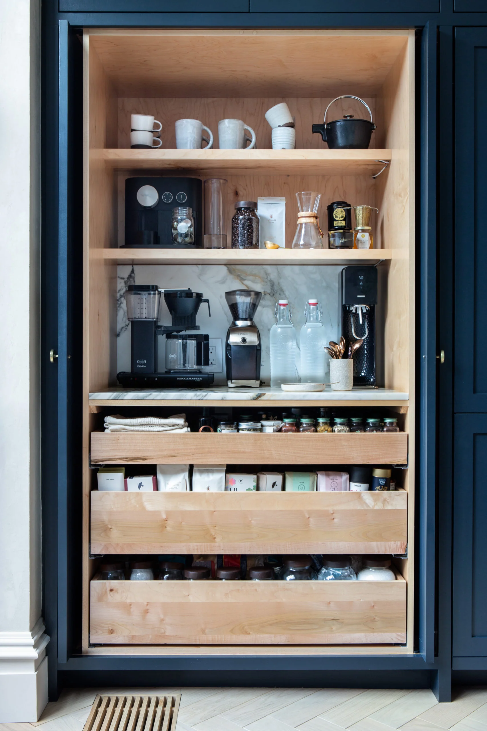 built-in coffee cabinet with all the machines able to tuck away behind cabinet doors