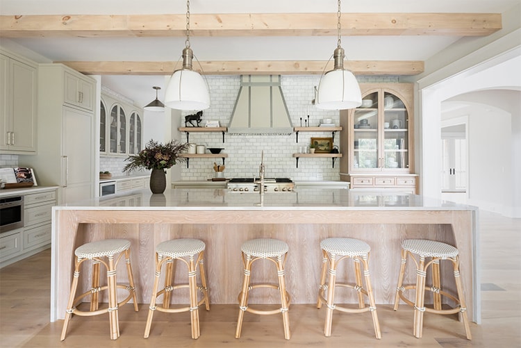 This kitchen designed by Studio 36 Design is SO stunning! I love all of the bright, neutral shades and those exposed wooden beams are so pretty! #ABlissfulNest