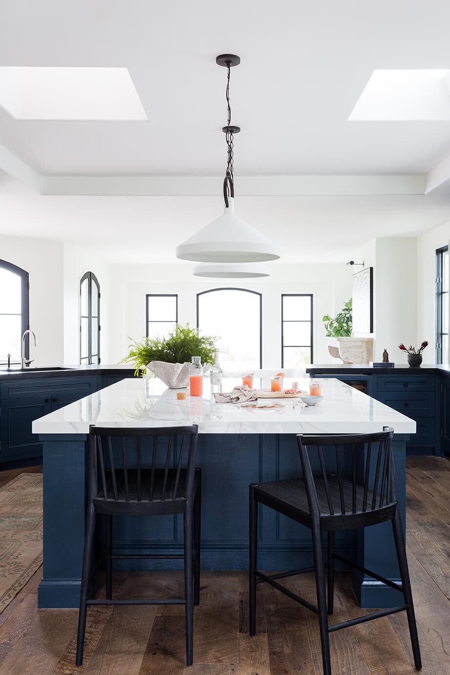 navy blue kitchen cabinets with black barstools