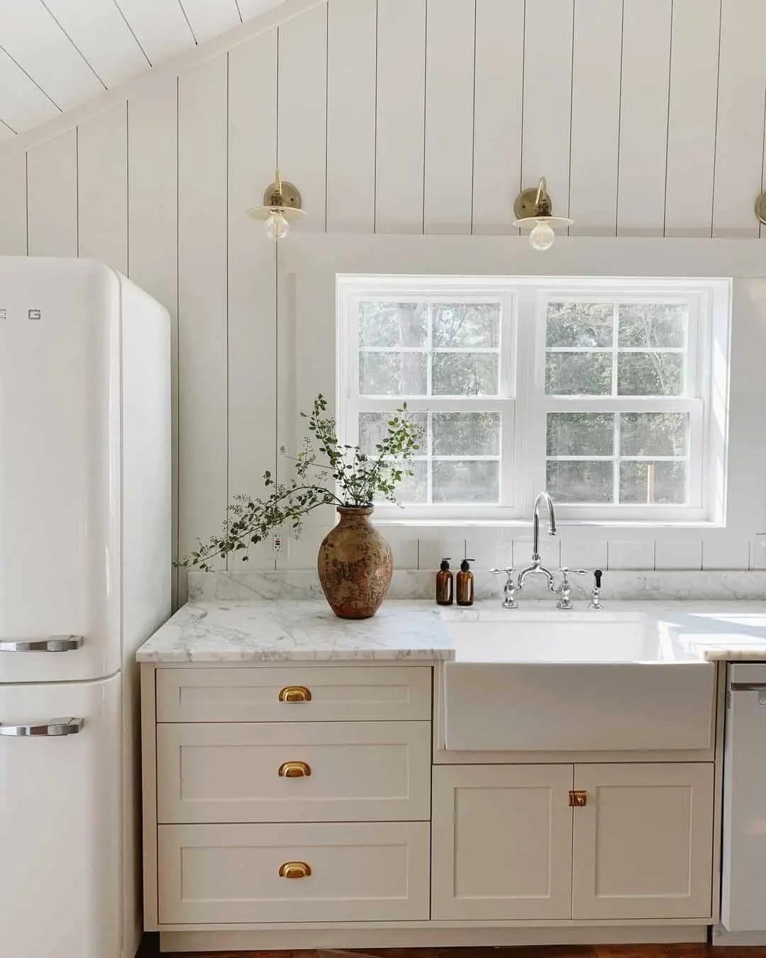 Beige Cabinets + Brass Hardware Bringing Charm To A Traditional Kitchen