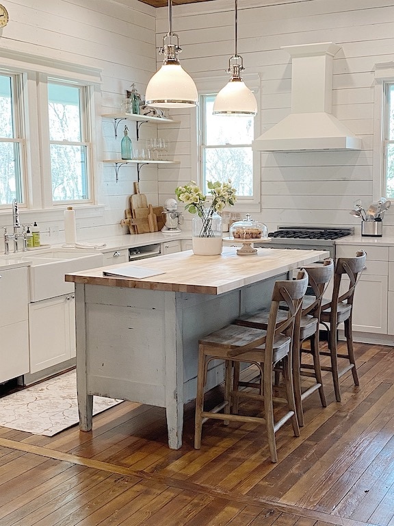 chippy blue gray kitchen island with butcher block countertop