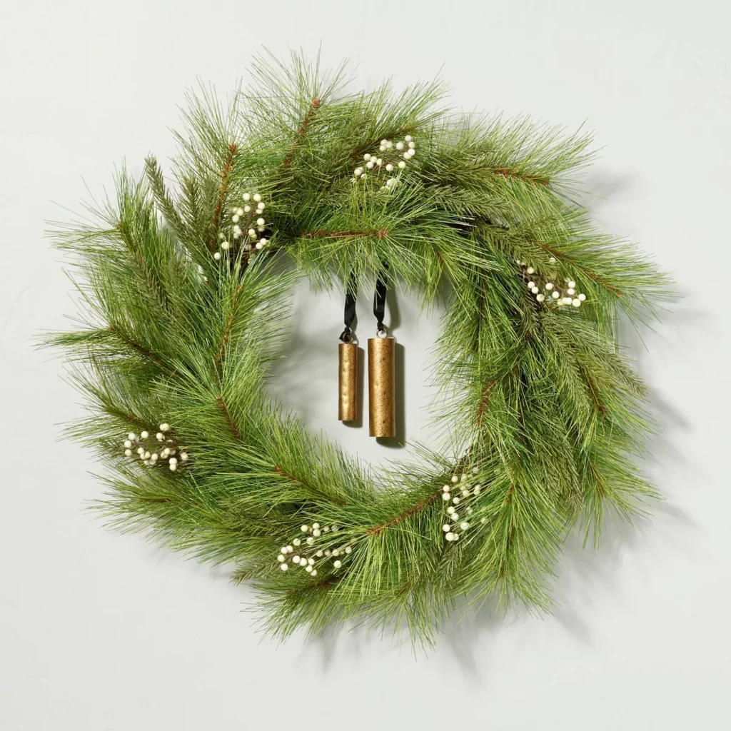 This faux needle pine wreath has white snowberries and the prettiest gold bells for a simplistic, under $50 holiday wreath! 