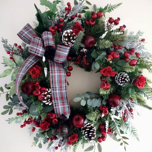 This red berry pine wreath has the prettiest plaid bow and it's the perfect under $200 Christmas wreath for your front door! #ABlissfulNest