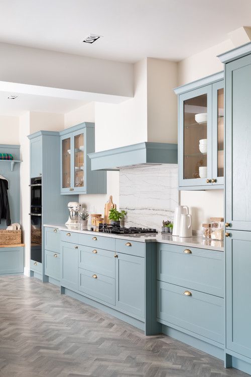 aqua kitchen cabinets with chevron wood floor and gold cabinet hardware