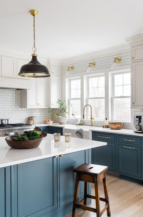 teal kitchen cabinets with black and gold lighting