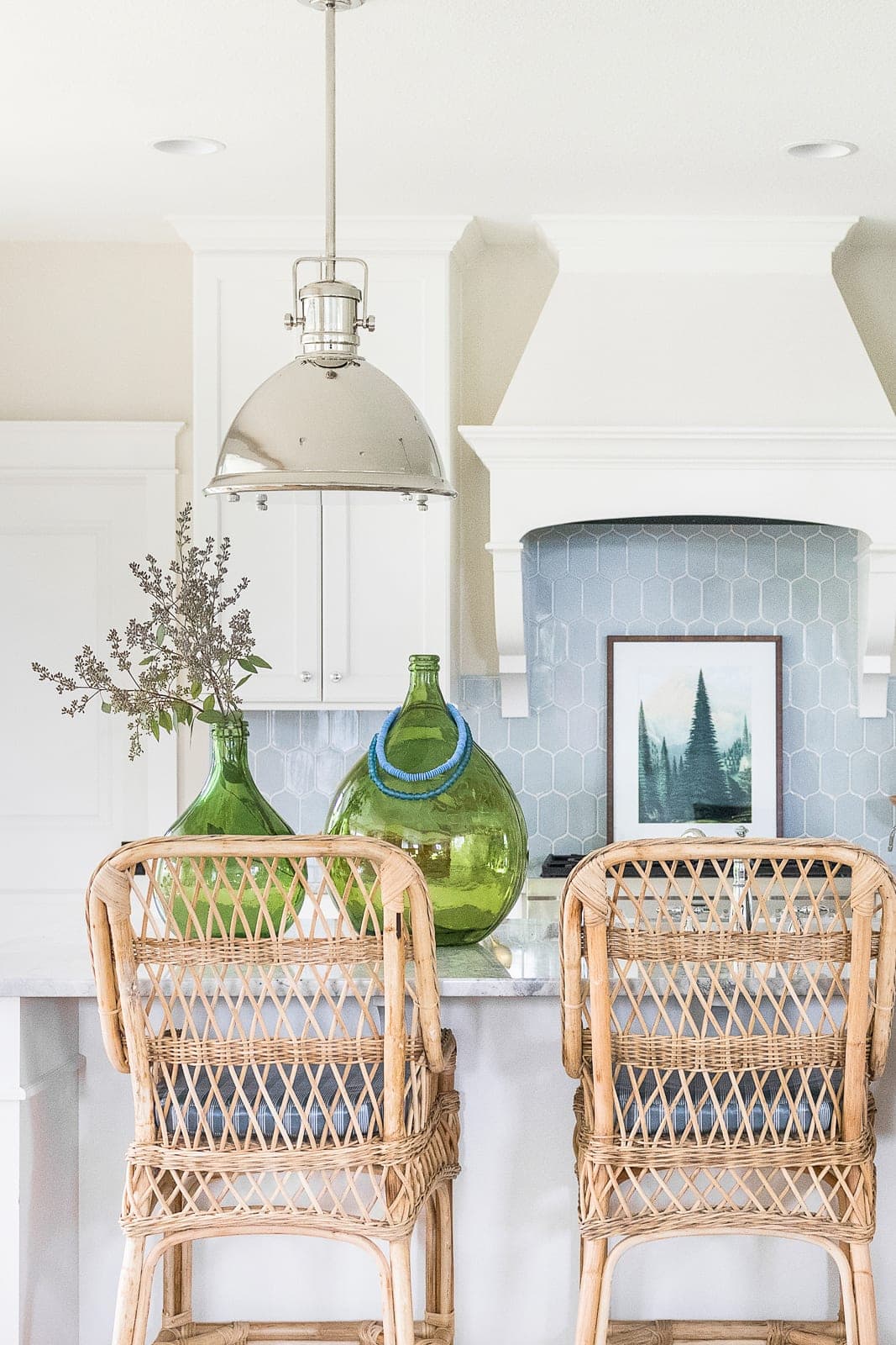 rattan barstools, green bottles on counter, blue tile backsplash