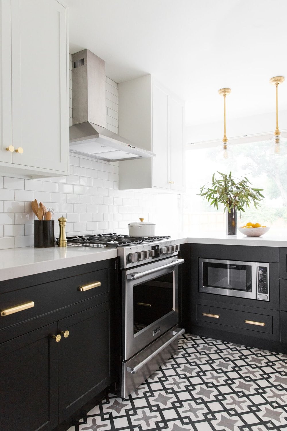 black base cabinets with white uppers and gold hardware
