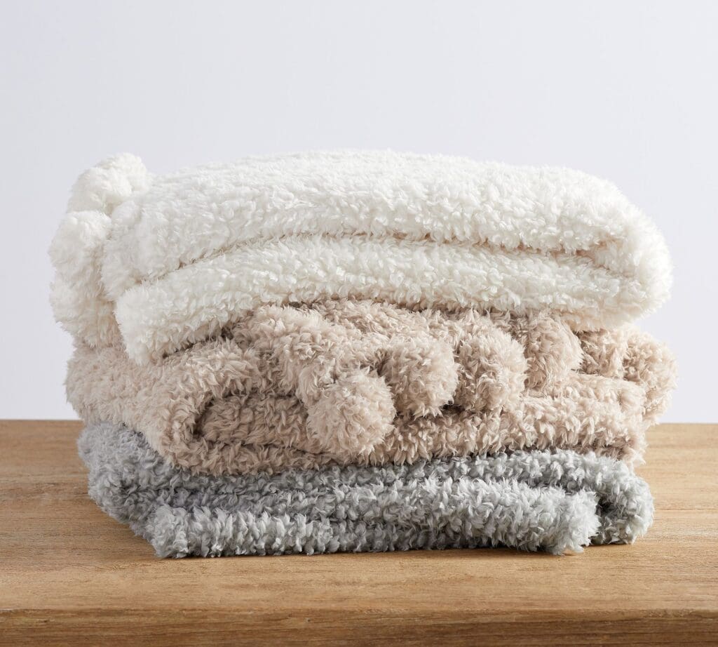 This cozy pom pom sherpa throw blanket is under $50 and a great holiday gift idea! #ABlissfulNest
