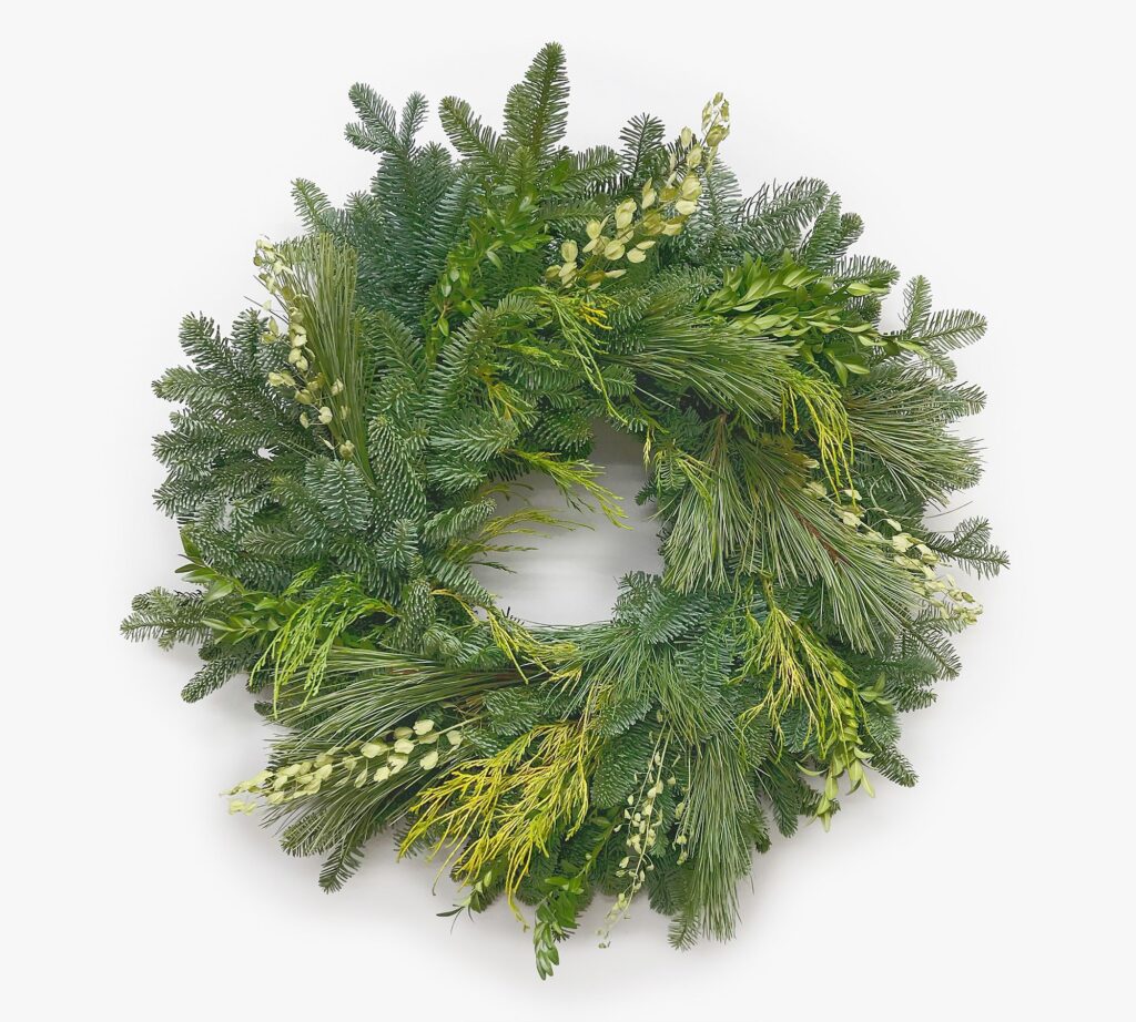 This fresh yule wreath is filled with the prettest, wintery mix of greenery stems and is the perfect neutral holiday wreath for your home this season! #ABlissfulNest