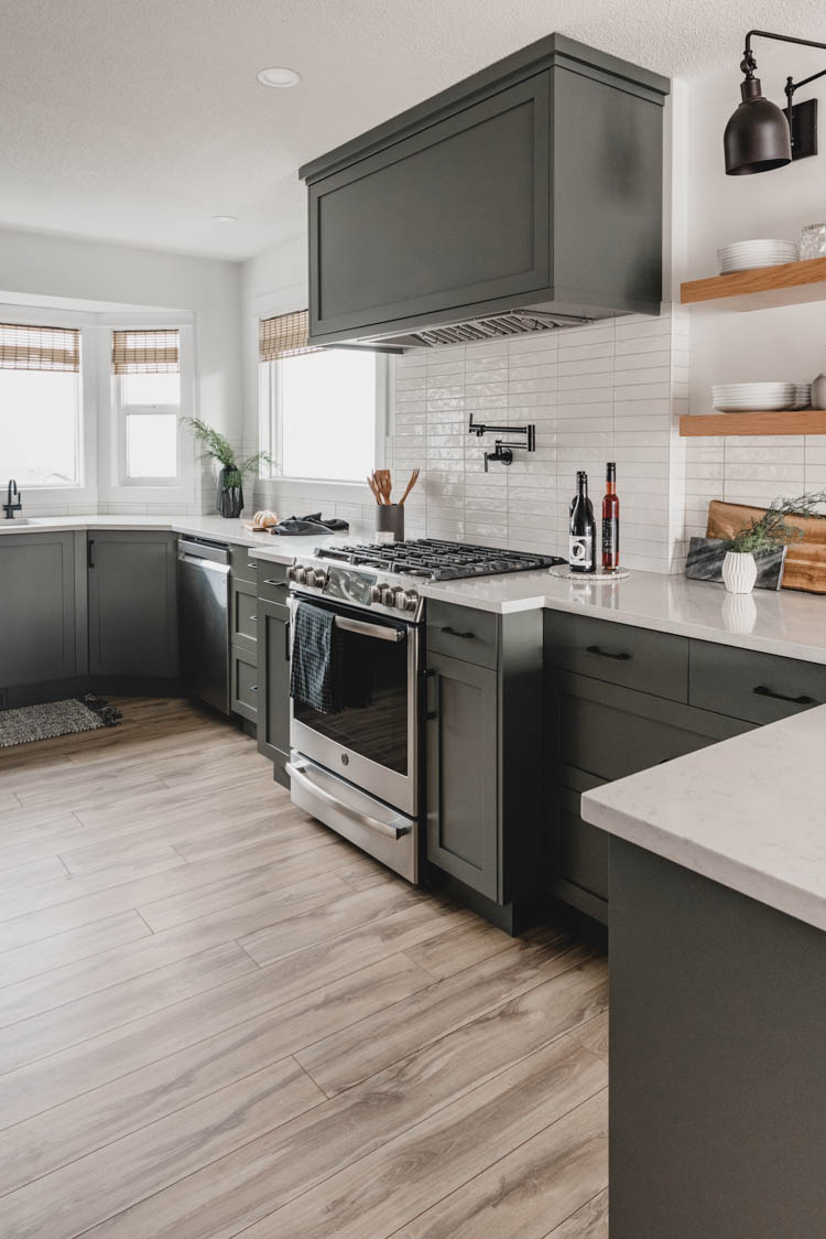 olive green kitchen cabinets with black hardware