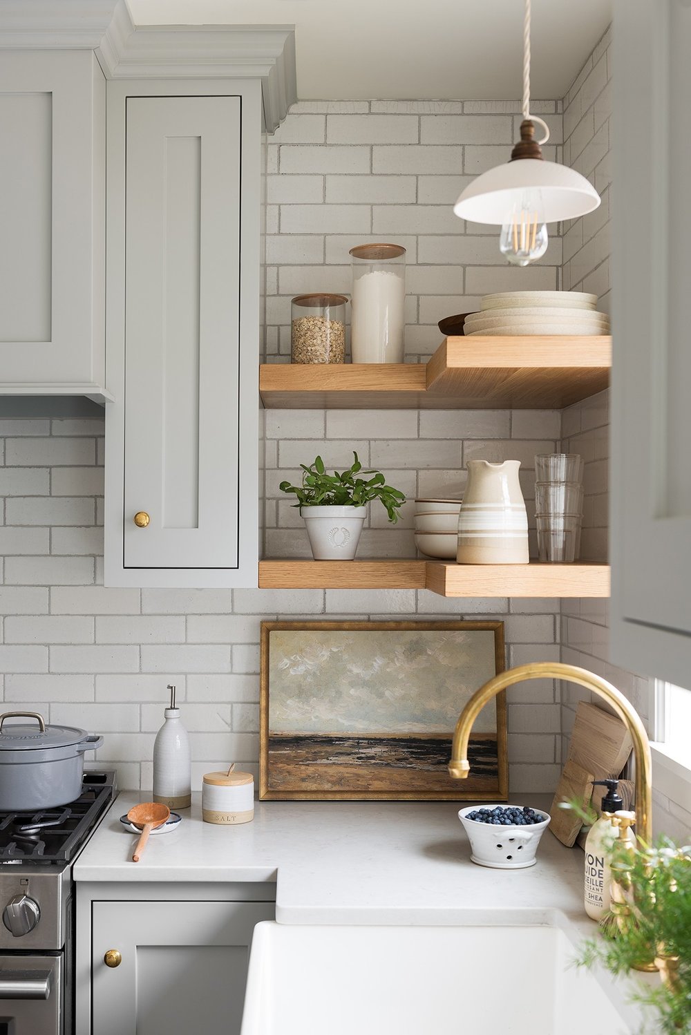 gray kitchen cabinets with gold faucet