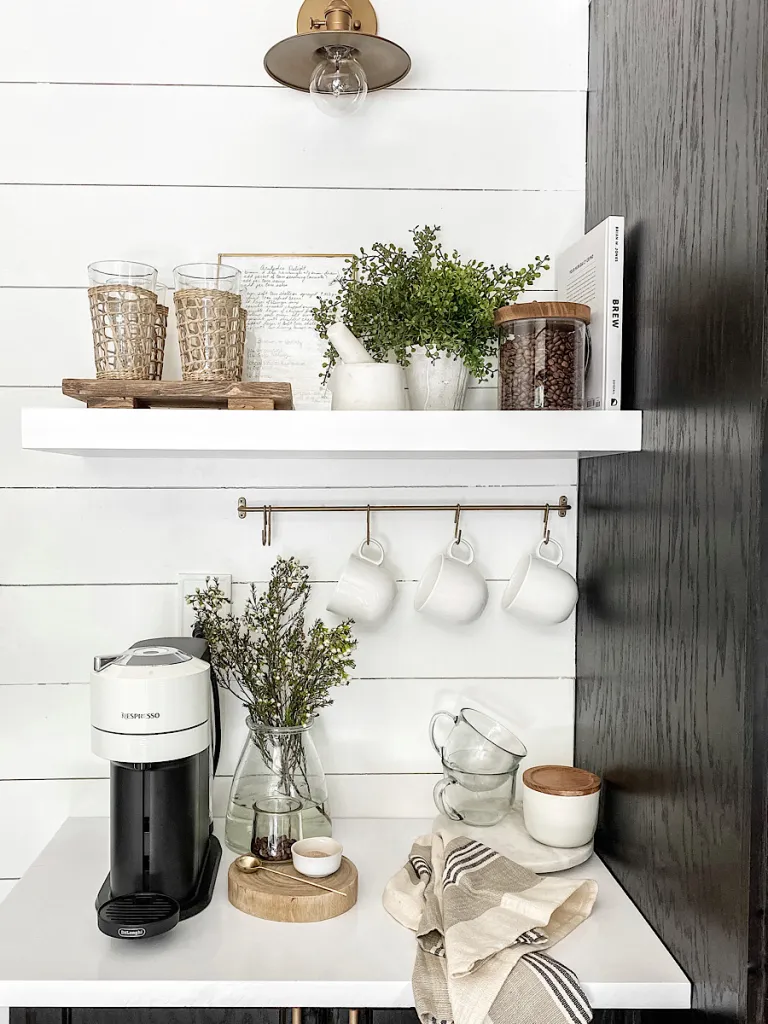 coffee station on white counter with floating shelves