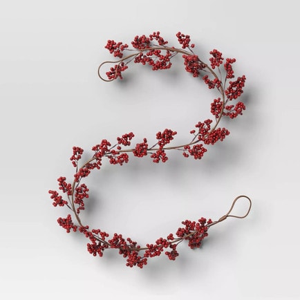This red berry holiday garland is $10 and the perfect holiday decor to add to your mantle or holiday tablescape this season! #ABlissfulNest