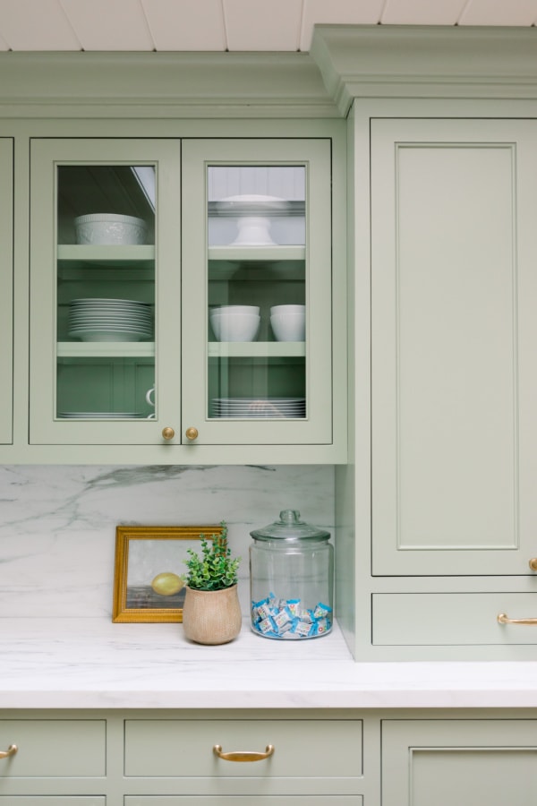 seafoam green kitchen cabinets with a white plank ceiling