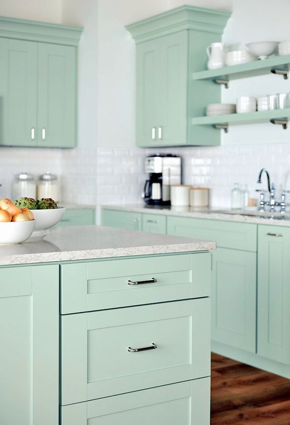 mint green cabinets with chrome hardware and light gray quartz counters