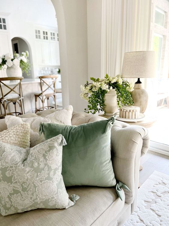 sage green pillows in a neutral living room