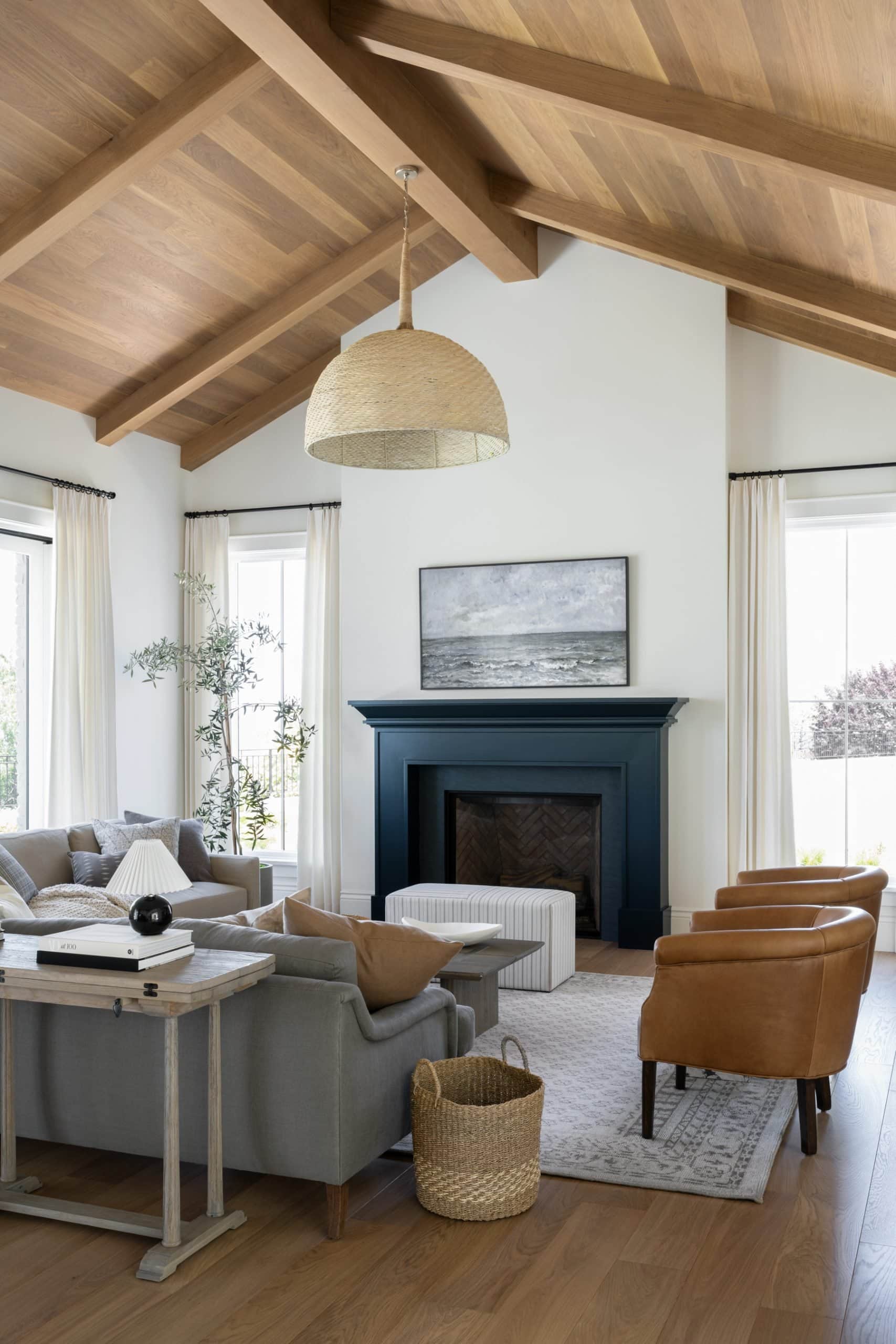 A rich navy painted fireplace with lighter toned furniture to accent it.