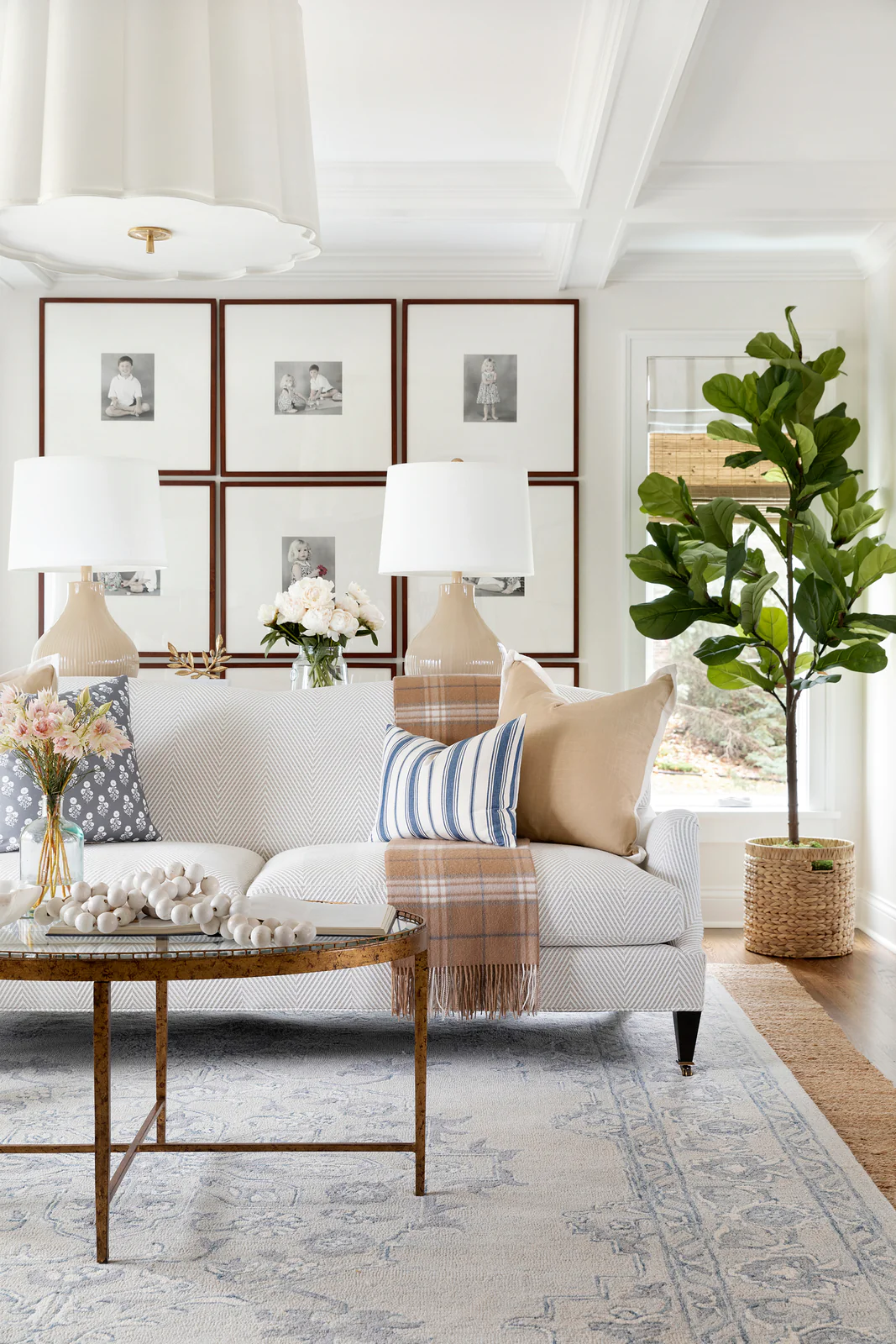 white walls with a jute area rug and large fiddle fig plant in a living room