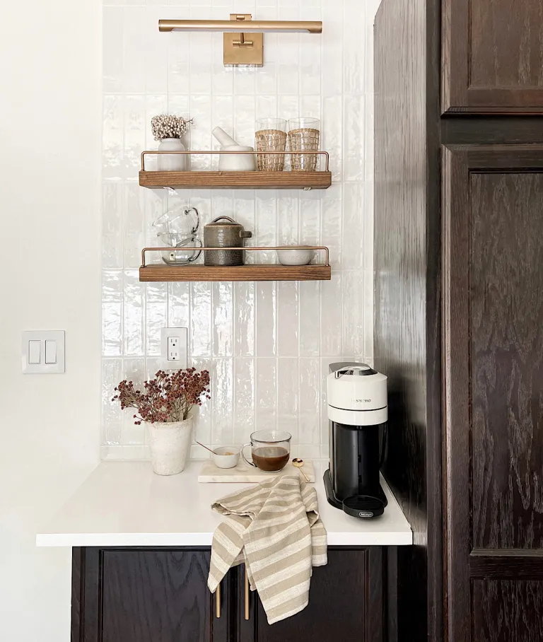 dark wood cabinets, white countertops, floating shelves, coffee bar set on the counter