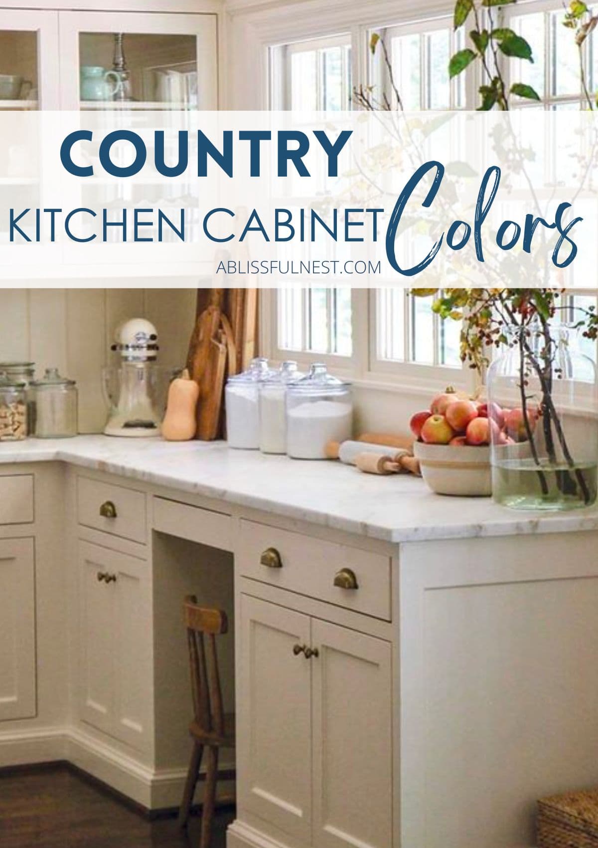 cream colored kitchen cabinets with gold cabinet hardware, wood flooring, and marble countertops