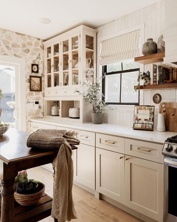 creamy beige paint mixed with gold cabinet hardware in a farmhouse kitchen.