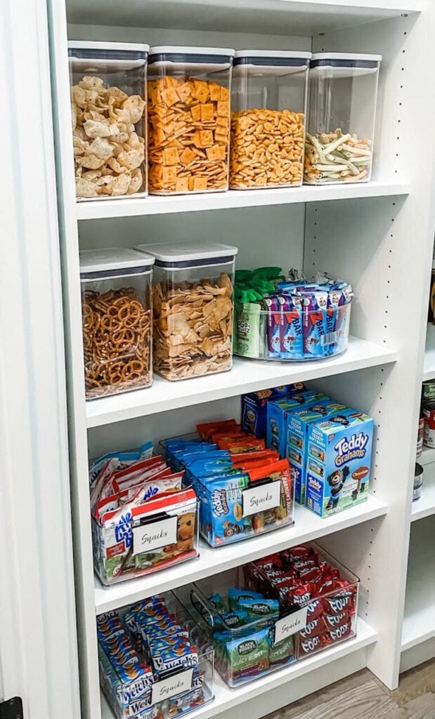 pantry shelves organized with clear bins