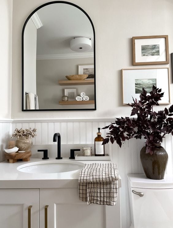 light gray cabinet with gold hardware mixed with black faucet in this modern farmhouse bathroom