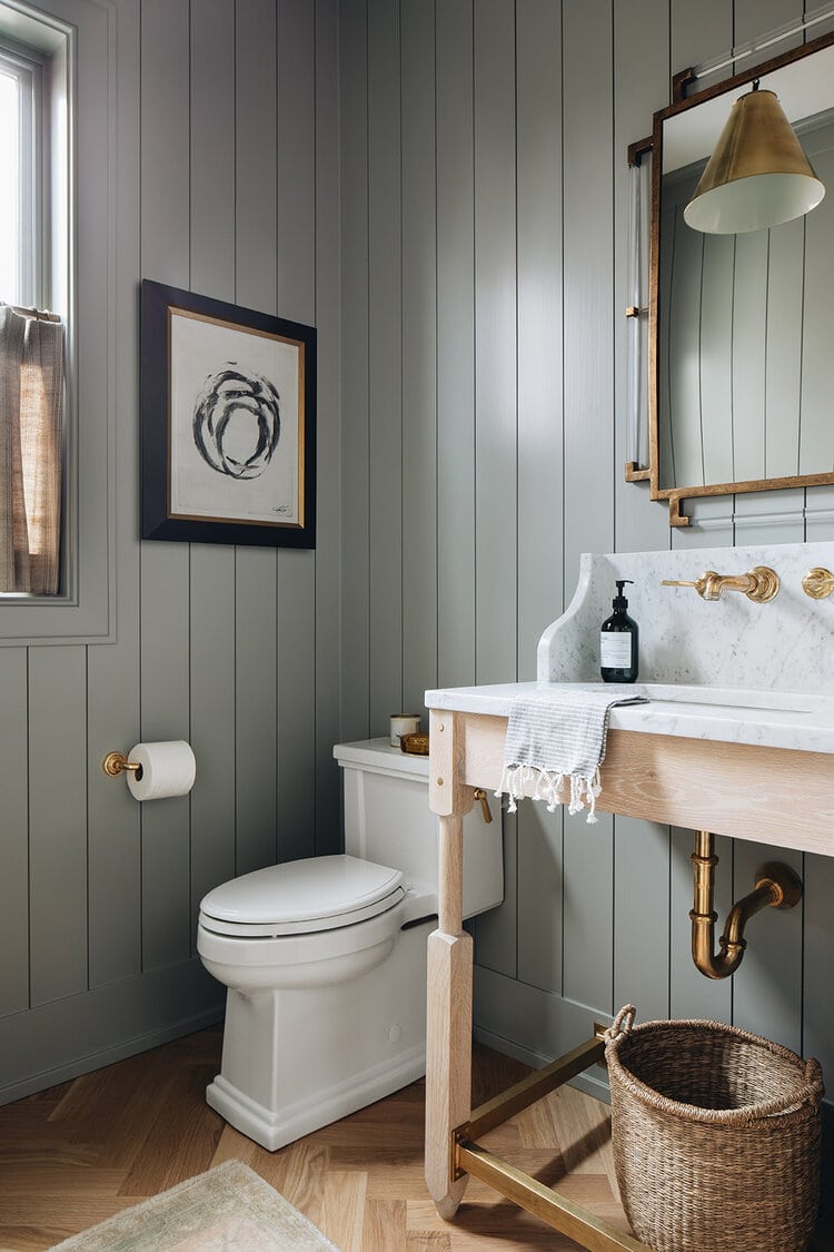 vertical shiplap in a porcelain blue shade with a vintage wood vanity cabinet for the sink.