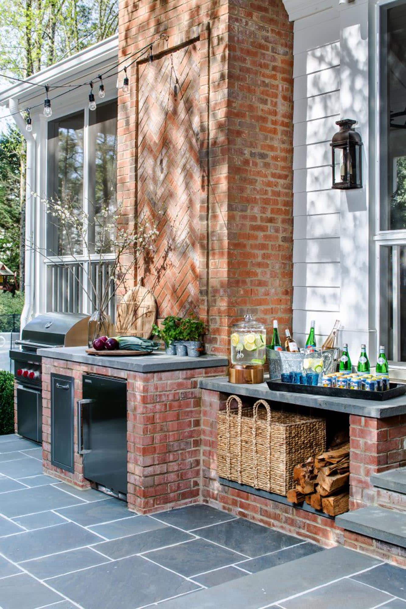 built in outdoor kitchen with a bar area using brick and concrete