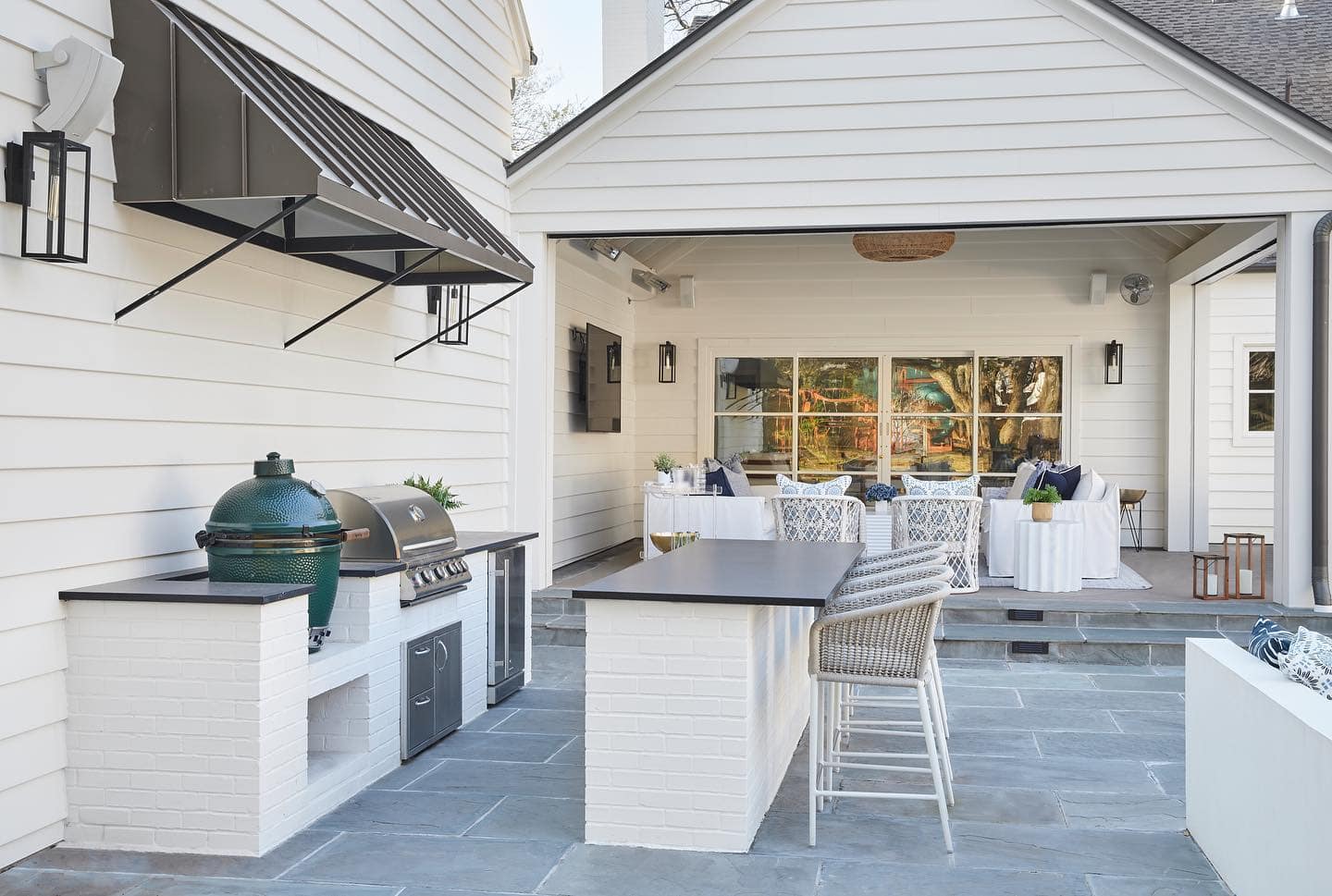 blue flagstone patio with a outdoor kitchen made from white brick