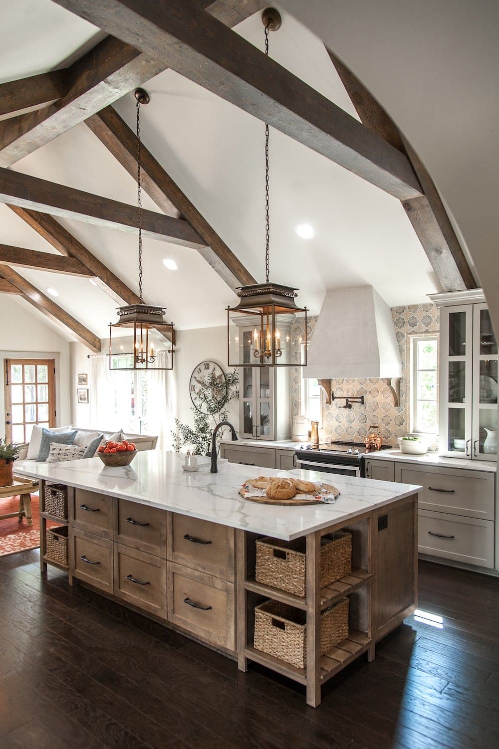 rustic wood kitchen island with white kitchen hood and french accent lanterns above the island.