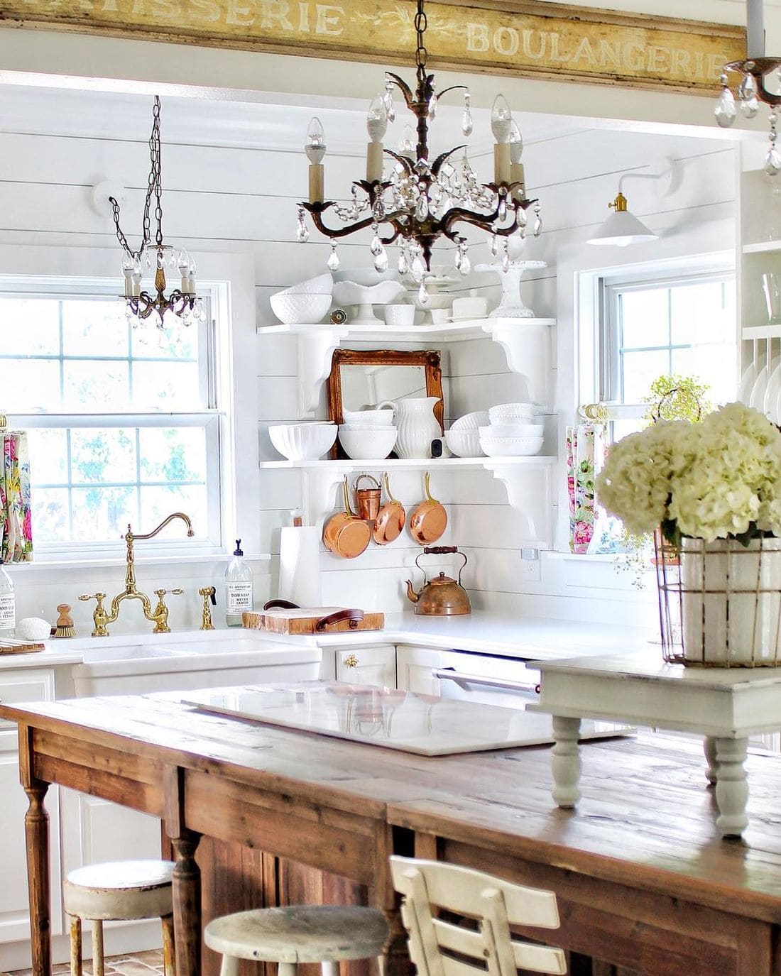 shiplap walls, brass kitchen faucet, vintage chandeliers in this vintage inspired French kitchen