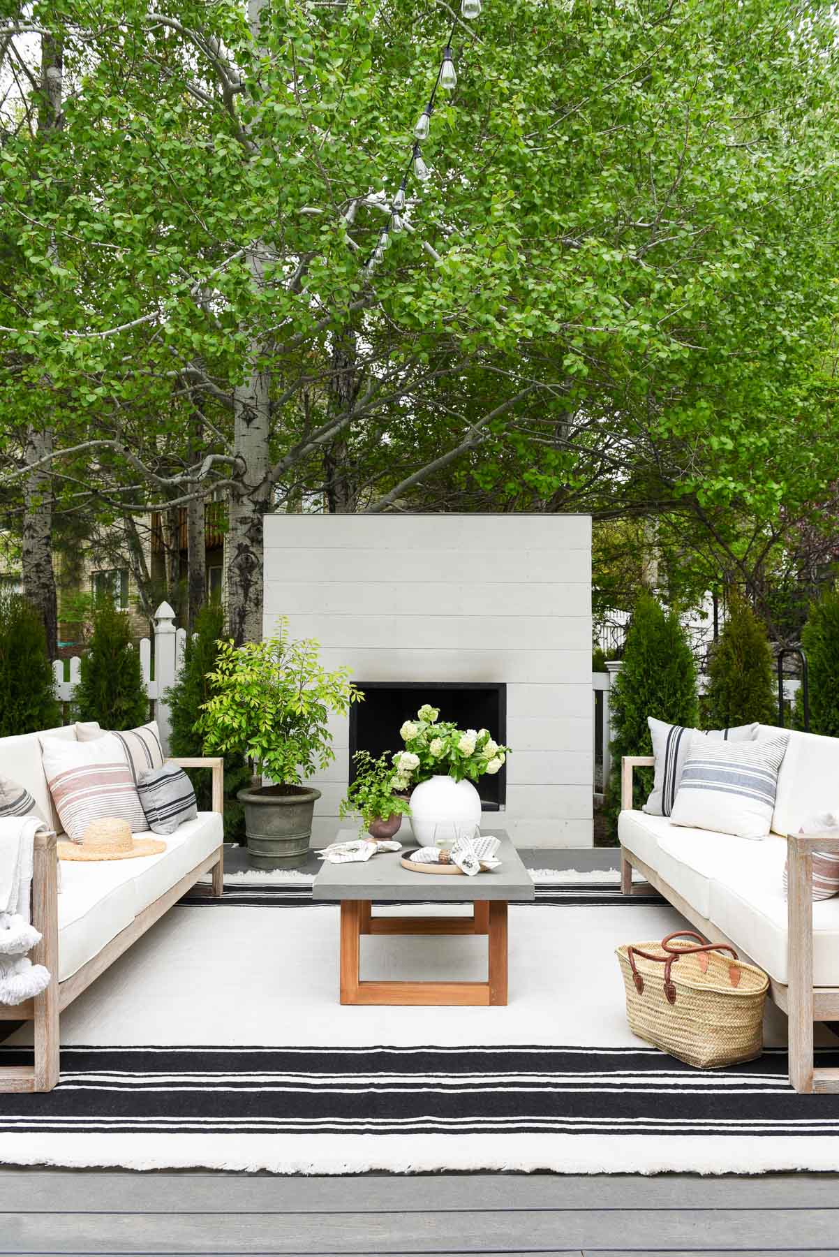 upholstered seating in a wood frame in front of a fireplace on a deck
